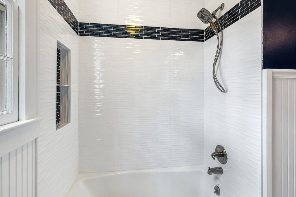 Bathroom shower with glass tile to accent the surround