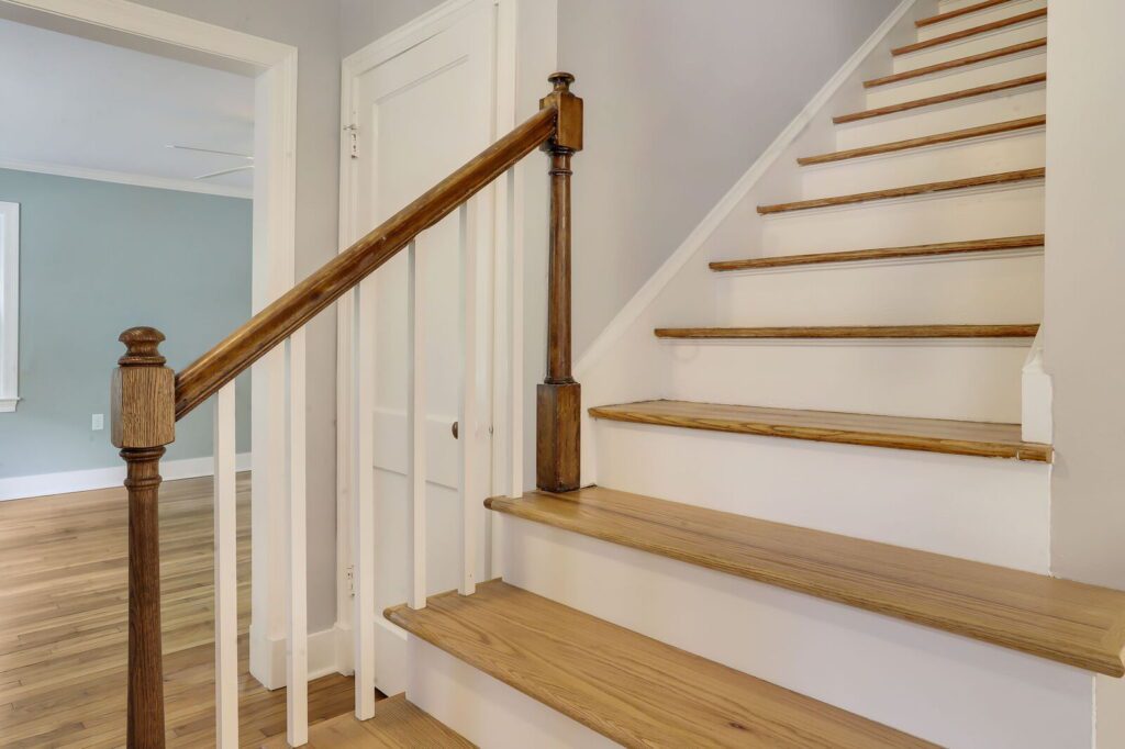 Home Addition with new stairs blending original wood finishes